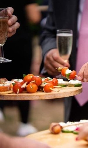 Bride and groom being served canapes